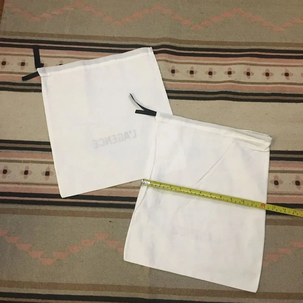 Two (2) L’Agence white w/ black lettering & drawstring Dustbag 15” x 12” new